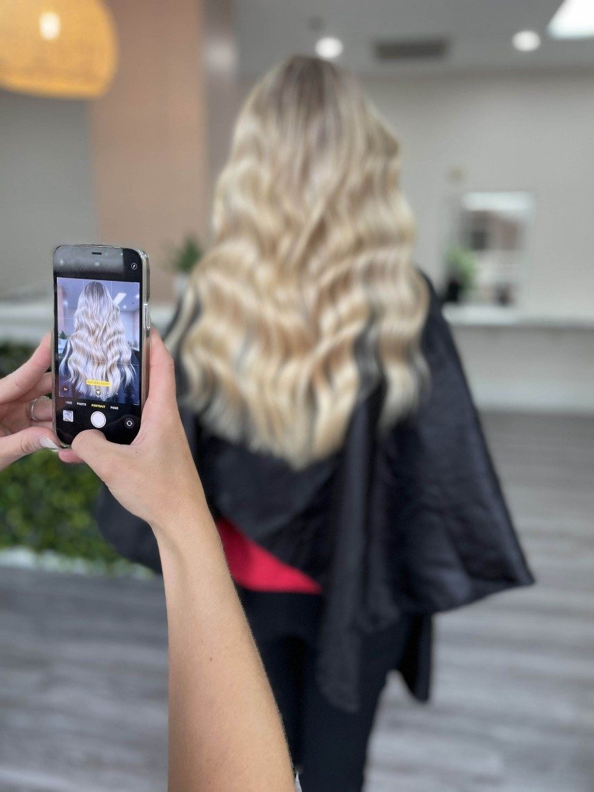 An iphone taking a photo of a clients hair